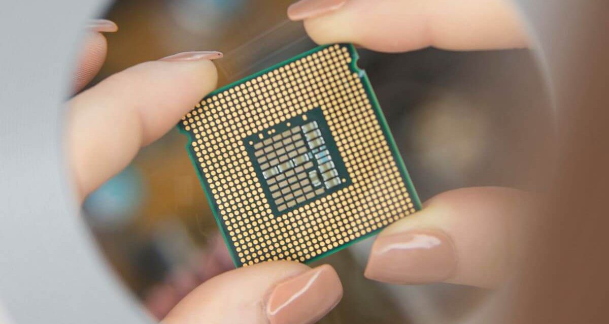 Close up of hands holding a computer chip